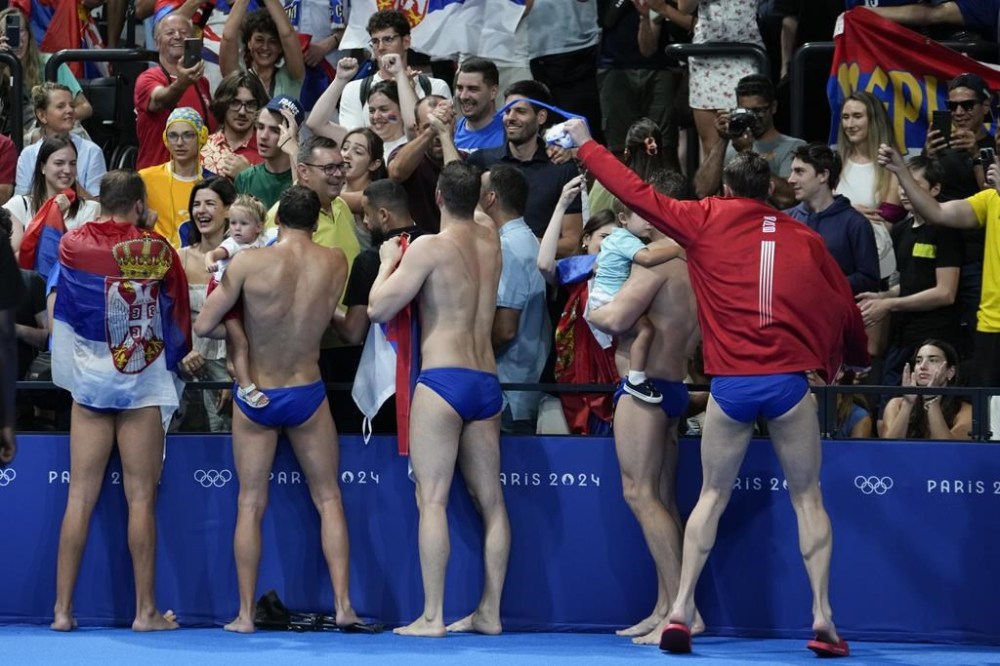 Serbia's team celebrates winning the men's water polo gold medal match against Croatia, at the 2024 Summer Olympics, Sunday, Aug. 11, 2024, in Paris, France. (AP Photo/Luca Bruno)