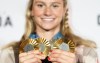 Canada's Summer McIntosh poses with her four medals won in the pool at the 2024 Summer Olympics, Monday, Aug. 5, 2024 in Paris, France. Nine gold medals and 27 total medals were both records for Canada at a non-boycotted Summer Olympics to surpass previous highs set in Tokyo three years ago and 1992 in Barcelona. THE CANADIAN PRESS/Christinne Muschi