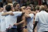 United States' head coach Dejan Udovicic, center, celebrates with players after winning the men's water polo bronze medal match against Hungary, at the 2024 Summer Olympics, Sunday, Aug. 11, 2024, in Paris, France. (AP Photo/Luca Bruno)