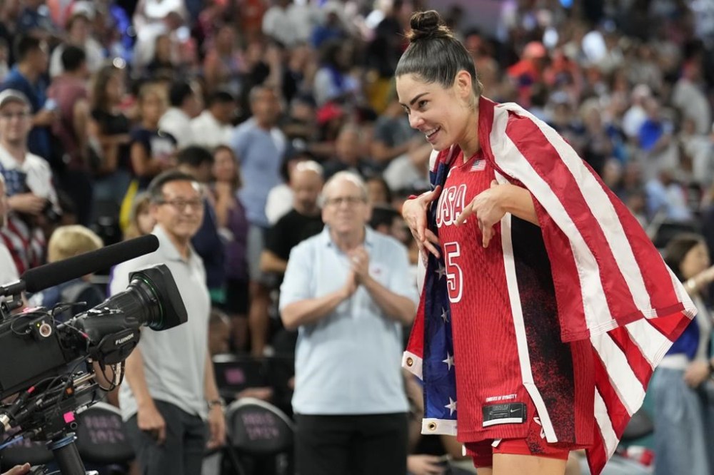 United States' Kelsey Plum (5) celebrates after a women's gold medal basketball game at Bercy Arena at the 2024 Summer Olympics, Sunday, Aug. 11, 2024, in Paris, France. (AP Photo/Mark J. Terrill)