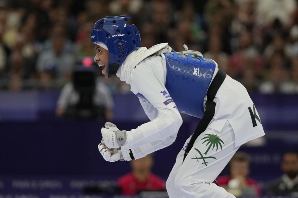 Saudi Arabia's Dunya Ali M Abutaleb reacts as she competes with Israel's Abishag Semberg in a women's 49kg Taekwondo match during the 2024 Summer Olympics, at the Grand Palais, Wednesday, Aug. 7, 2024, in Paris, France. (AP Photo/Andrew Medichini)