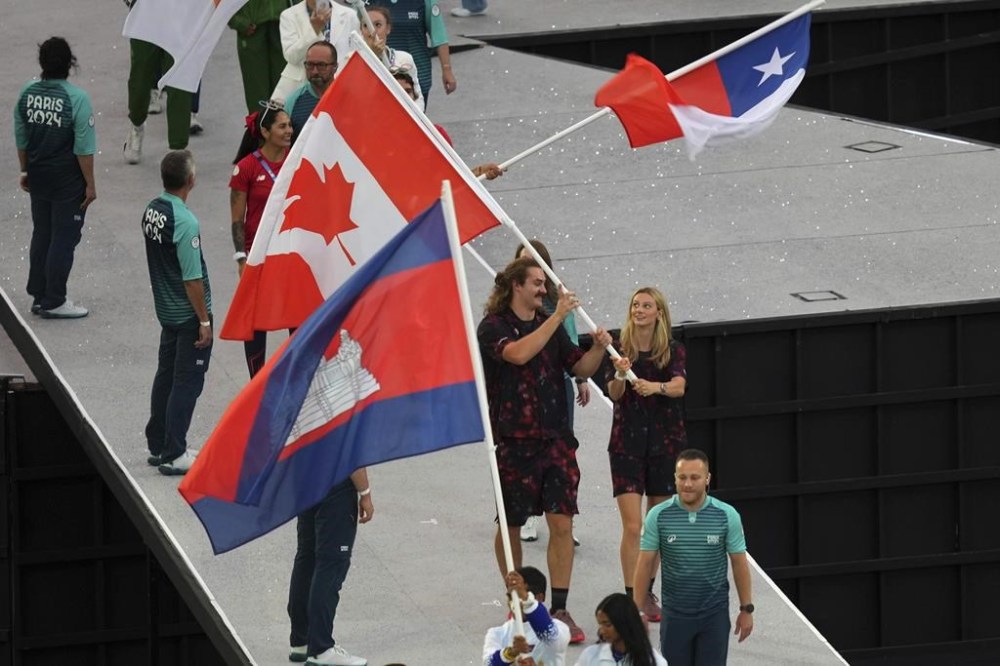 Canadian flag-bearers Ethan Katzberg and Summer Macintosh parade during the 2024 Summer Olympics closing ceremony at the Stade de France, Sunday, Aug. 11, 2024, in Saint-Denis, France. THE CANADIAN PRESS/AP -Dita Alangkara