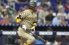 San Diego Padres' Luis Arraez watches after hitting a single during the fourth inning of a baseball game against the Miami Marlins, Sunday, Aug. 11, 2024, in Miami. (AP Photo/Lynne Sladky)