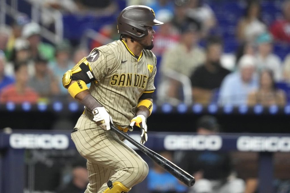 San Diego Padres' Luis Arraez watches after hitting a single during the fourth inning of a baseball game against the Miami Marlins, Sunday, Aug. 11, 2024, in Miami. (AP Photo/Lynne Sladky)