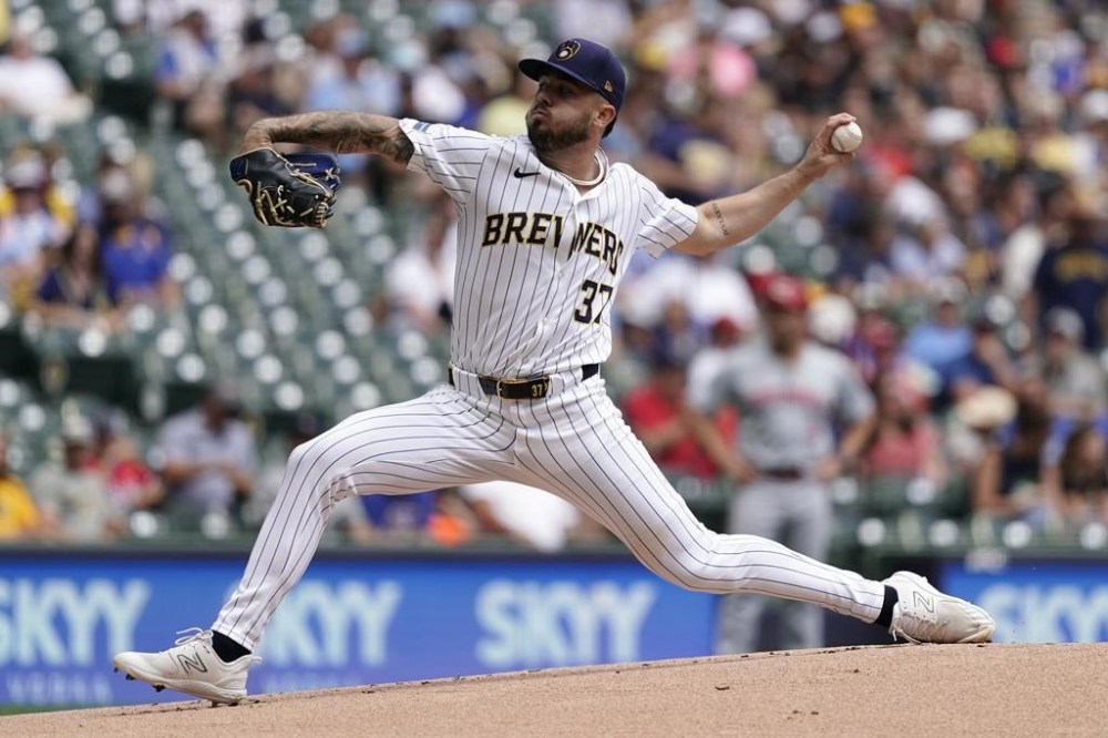Milwaukee Brewers' DL Hall pitches during the first inning of a baseball game against the Cincinnati Reds, Sunday, Aug. 11, 2024, in Milwaukee. (AP Photo/Aaron Gash)