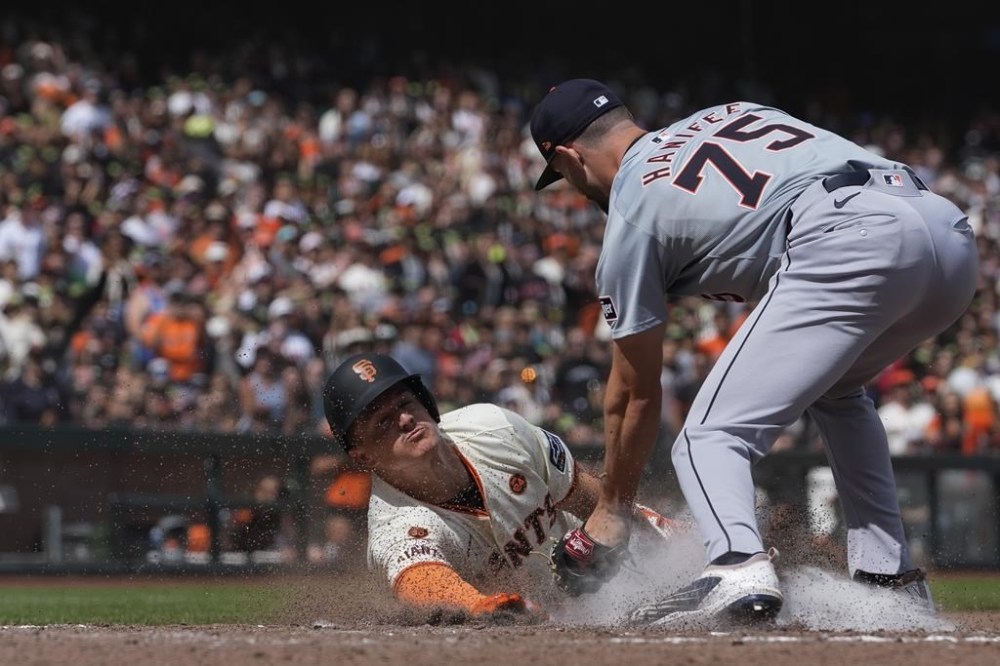 Detroit Tigers pitcher Brenan Hanifee, right, tags out San Francisco Giants' Matt Chapman at home during the eighth inning of a baseball game Sunday, Aug. 11, 2024, in San Francisco. (AP Photo/Godofredo A. Vásquez)