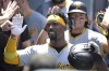 Pittsburgh Pirates' Andrew McCutchen is congratulated in the dugout after hitting a two-run home run in the third inning of a baseball game against the Los Angeles Dodgers, Sunday, Aug. 11, 2024, in Los Angeles. (AP Photo/Jayne-Kamin-Oncea)