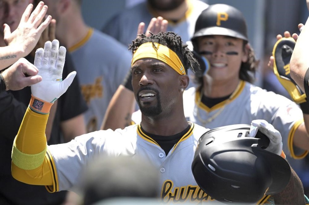 Pittsburgh Pirates' Andrew McCutchen is congratulated in the dugout after hitting a two-run home run in the third inning of a baseball game against the Los Angeles Dodgers, Sunday, Aug. 11, 2024, in Los Angeles. (AP Photo/Jayne-Kamin-Oncea)