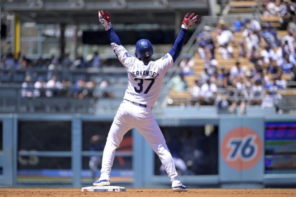 Los Angeles Dodgers' Teoscar Hernandez gestures after hitting a two RBI double in the second inning during a baseball game against the Pittsburgh Pirates Sunday, Aug. 11, 2024, in Los Angeles. (AP Photo/Jayne-Kamin-Oncea)