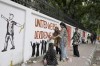 Students create graffiti in Dhaka, Bangladesh, Saturday, Aug. 10, 2024. (AP Photo/Fatima Tuj Johora)