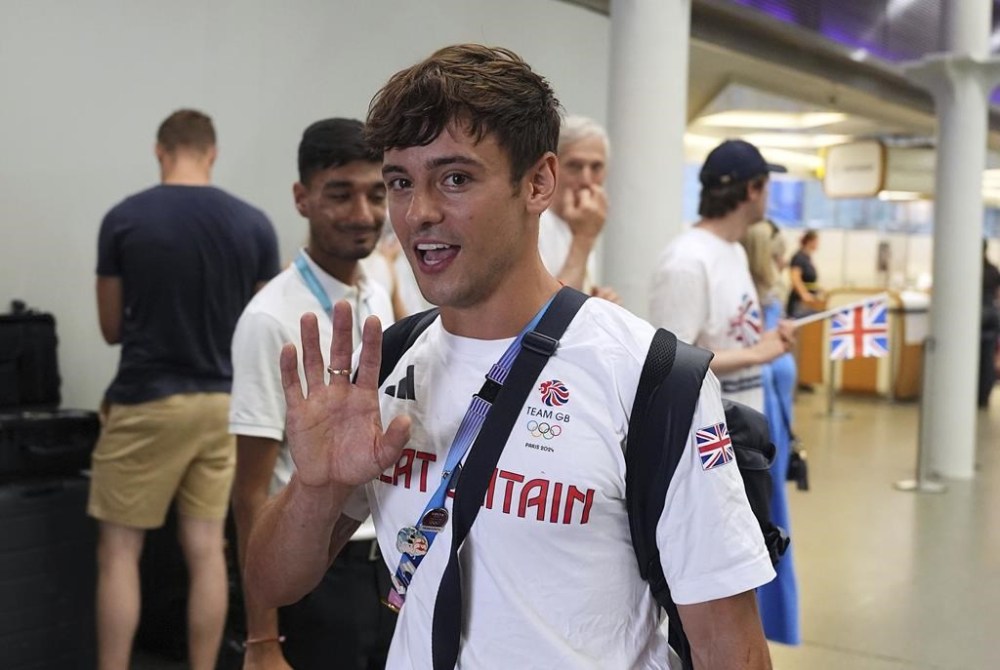 Great Britain's Tom Daley arrives by Eurostar into London St. Pancras International train station after competing at the 2024 Paris Olympic Games in France, Monday Aug. 12, 2024. Five-time Olympic gold medalist Tom Daley has announced his retirement from diving. (Jordan Pettitt/PA via AP)
