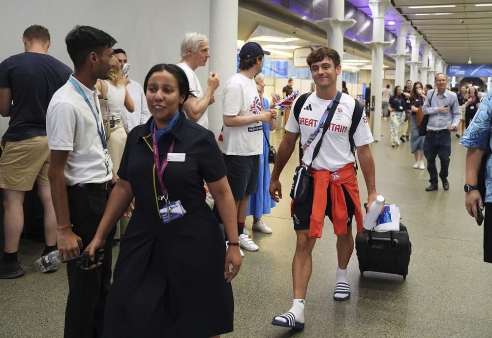 Great Britain's Tom Daley arrives by Eurostar into London St. Pancras International train station after competing at the 2024 Paris Olympic Games in France, Monday Aug. 12, 2024. Five-time Olympic gold medalist Tom Daley has announced his retirement from diving. (Jordan Pettitt/PA via AP)