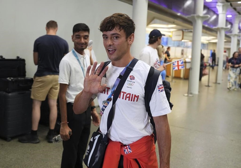 Great Britain's Tom Daley arrives by Eurostar into London St. Pancras International train station after competing at the 2024 Paris Olympic Games in France, Monday Aug. 12, 2024. Five-time Olympic gold medalist Tom Daley has announced his retirement from diving. (Jordan Pettitt/PA via AP)