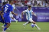 Argentina's Julian Alvarez fights for the ball with during a quarter final soccer match between France and Argentina, at Bordeaux Stadium, during the 2024 Summer Olympics, Friday, Aug. 2, 2024, in Bordeaux, France. (AP Photo/Moises Castillo)
