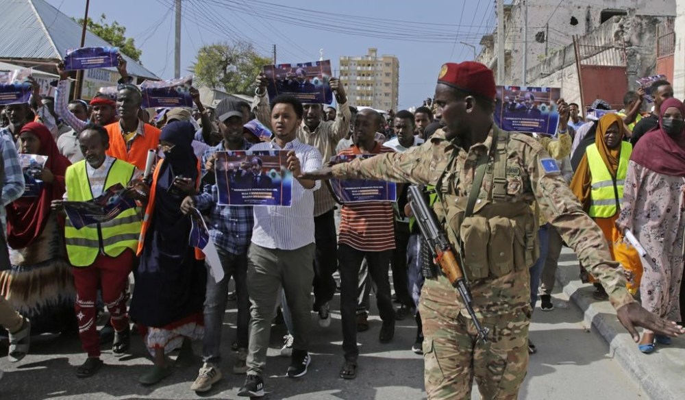 FILE - A Somali soldier controls the crowd as thousands of people attend a protest rally in Mogadishu, Somalia, Wednesday Jan.3, 2024, after being angry with an agreement signed between Ethiopia and the breakaway region of Somaliland to give landlocked Ethiopia access to its shoreline. (AP Photo/Farah Abdi Warsameh, File)