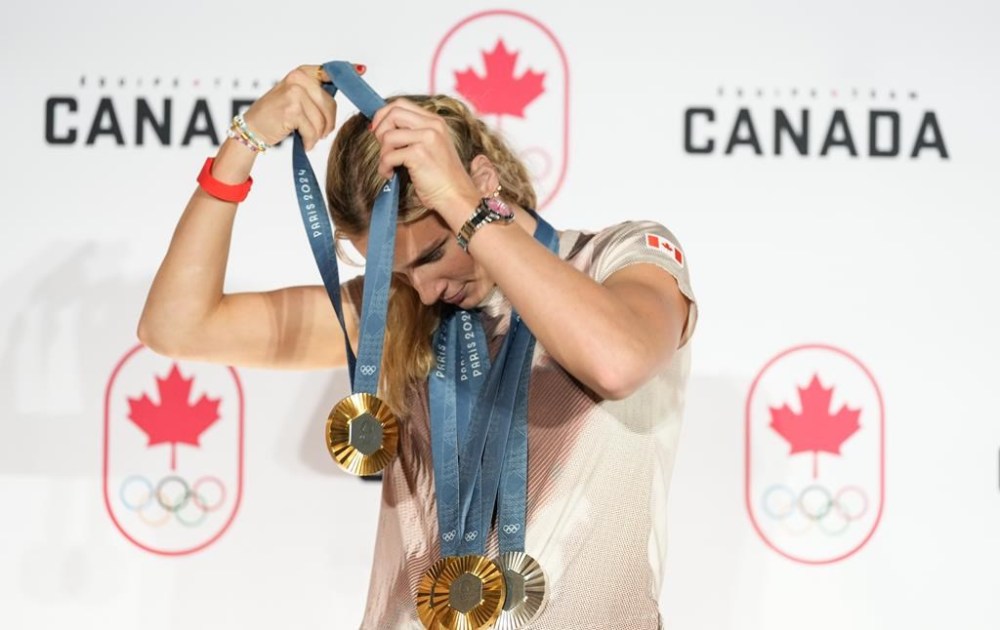Canada's Summer McIntosh of Toronto poses with her four medals won in the pool at the 2024 Summer Olympics, Aug. 5, 2024 in Paris, France. The three gold medals were for the 200m Butterfly, the 200m Individual Medley and the 400m Individual Medley and the one silver was for the 400m Freestyle. The Paris Games are over and the Summer Olympics torch is moving on to Los Angeles in 2028. THE CANADIAN PRESS/Christinne Muschi
