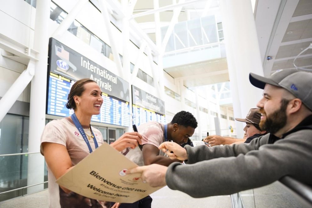 Olympic medalists Joshua Liendo and Kylie Masse sign autographs for fans after arriving at Pearson airport following the Paris 2024 Olympic Games, in Toronto, Monday, Aug. 12, 2024. THE CANADIAN PRESS/Christopher Katsarov