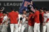 Boston Red Sox's Rob Refsnyder, center, celebrates after his winning RBI single in the 10th inning of a baseball game against the Texas Rangers at Fenway Park, Monday, Aug. 12, 2024, in Boston. (AP Photo/Charles Krupa)