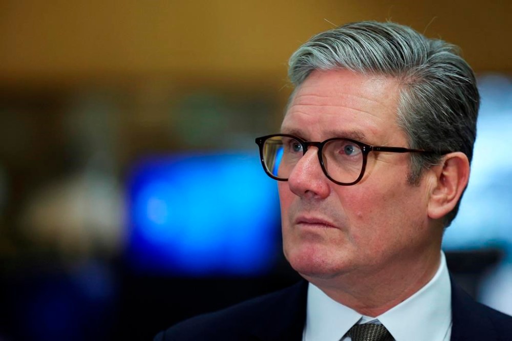 British Prime Minister Keir Starmer looks on at the Metropolitan Police Command and Control Special Operations Room at Lambeth Police Headquarters in London, Friday Aug. 9, 2024. (Toby Melville/Pool photo via AP)