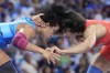 India's Vinesh Vinesh and Cuba's Yusneylys Guzman, left, compete during their women's freestyle 50kg wrestling semifinal match, at Champ-de-Mars Arena, during the 2024 Summer Olympics, Tuesday, Aug. 6, 2024, in Paris, France. (AP Photo/Eugene Hoshiko)