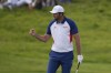 Scottie Scheffler, of the United States, reacts after making a birdie on the 2nd green during the final round of the men's golf at the 2024 Summer Olympics, Sunday, Aug. 4, 2024, at Le Golf National in Saint-Quentin-en-Yvelines, France. (AP Photo/George Walker IV)