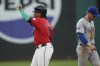 Cleveland Guardians' Jose Ramirez, left, gestures at second base in front of Chicago Cubs second baseman Nico Hoerner, right, after hitting a double in the third inning of a baseball game, Tuesday, Aug. 13, 2024, in Cleveland. (AP Photo/Sue Ogrocki)