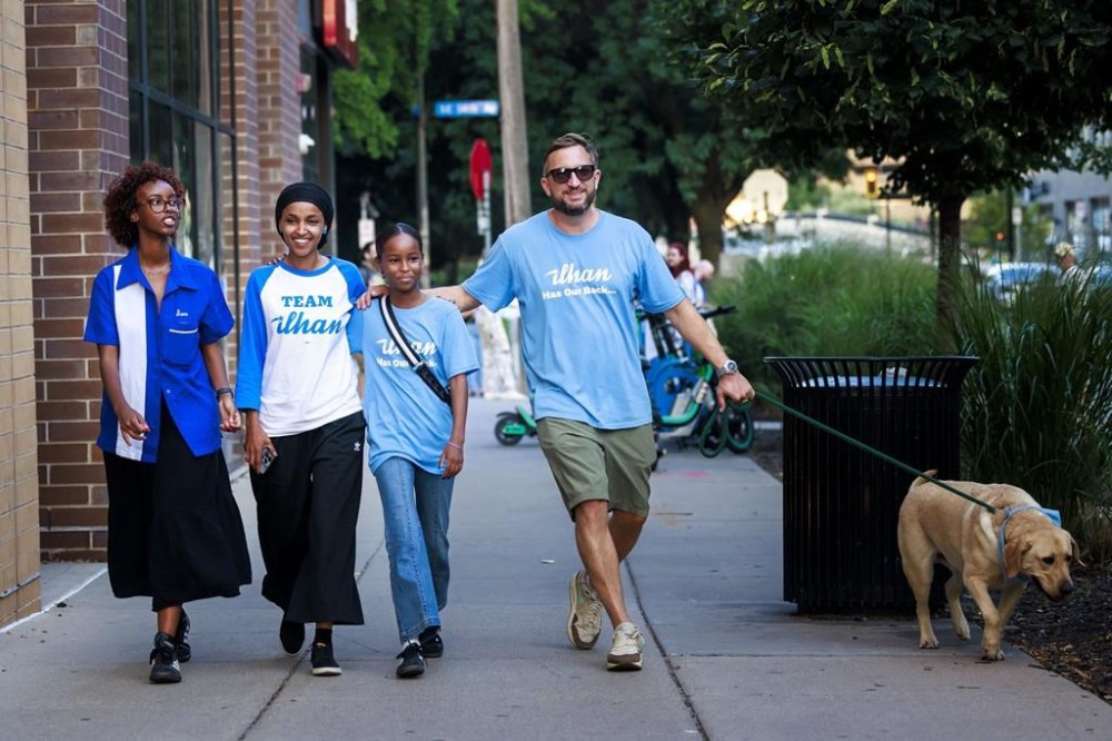 Rep. Ilhan Omar, second from left, walks with her daughters, Isra Hirsi, right, and Ilwad Hirsi, left, and her husband, Tim Mynett, after she talked with media during a campaign stop in Minneapolis, Tuesday, Aug. 13, 2024. (Kerem Yücel/Minnesota Public Radio via AP)