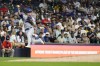 Los Angeles Dodgers' Enrique Hernández jumps after fielding a ground ball hit by Milwaukee Brewers' Joey Ortiz during the seventh inning of a baseball game Tuesday, Aug. 13, 2024, in Milwaukee. Ortiz was safe on the play. (AP Photo/Aaron Gash)