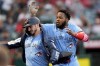 Toronto Blue Jays' Spencer Horwitz, left, is given a ceremonial jacket by Vladimir Guerrero Jr. after hitting a solo-home run during the third inning of a baseball game against the Los Angeles Angels, Tuesday, Aug. 13, 2024, in Anaheim, Calif. (AP Photo/Ryan Sun)