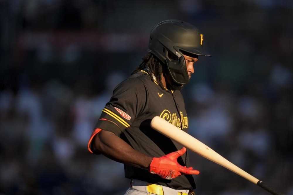 Pittsburgh Pirates' Oneil Cruz tosses his bat as he walks back to the dugout after popping out during the first inning of a baseball game against the San Diego Padres, Tuesday, Aug. 13, 2024, in San Diego. (AP Photo/Gregory Bull)