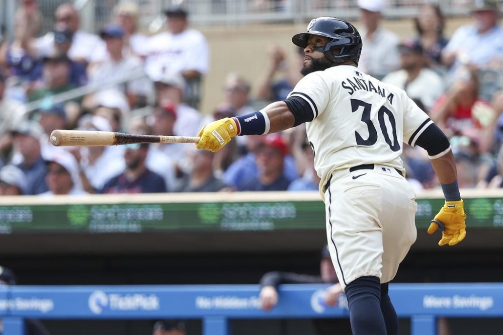 Minnesota Twins' Carlos Santana watches his solo home run during the fourth inning of a baseball game against the Kansas City Royals, Wednesday, Aug. 14, 2024, in Minneapolis. (AP Photo/Matt Krohn)