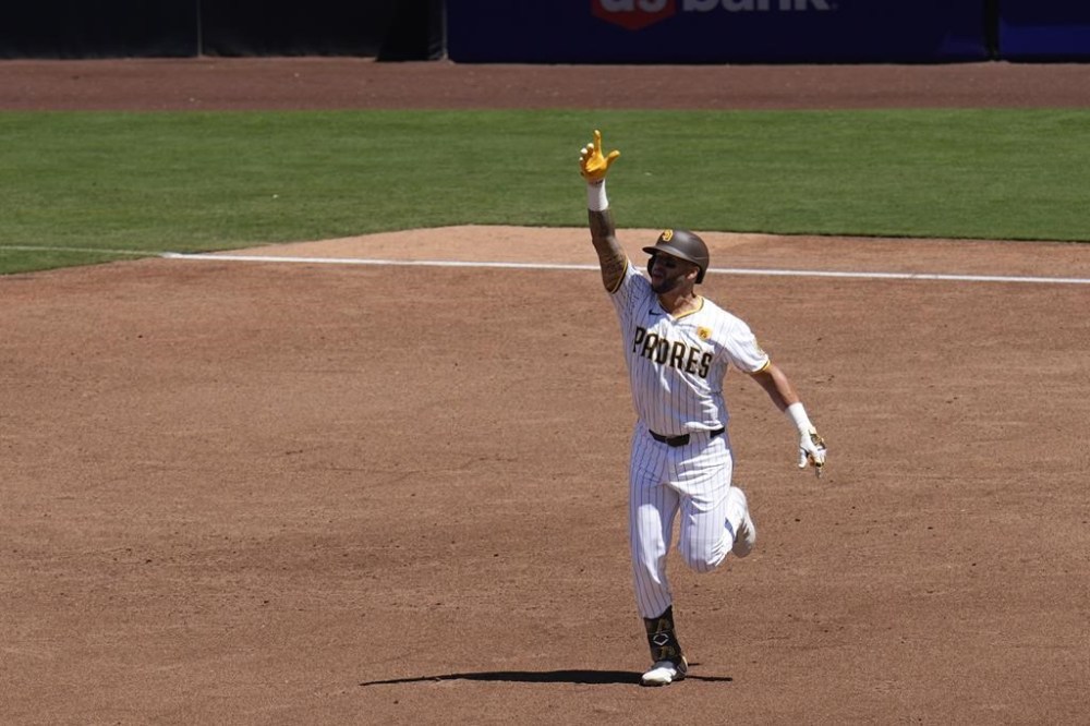San Diego Padres' David Peralta celebrates after hitting a two-run home run during the third inning of a baseball game Wednesday, Aug. 14, 2024, in San Diego. (AP Photo/Gregory Bull)