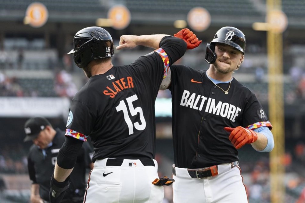 Baltimore Orioles' Gunnar Henderson, right, celebrates with Austin Slater (15) after hitting a home run during the first inning of a baseball game against the Washington Nationals, Wednesday, Aug. 14, 2024, in Baltimore. (AP Photo/Stephanie Scarbrough)