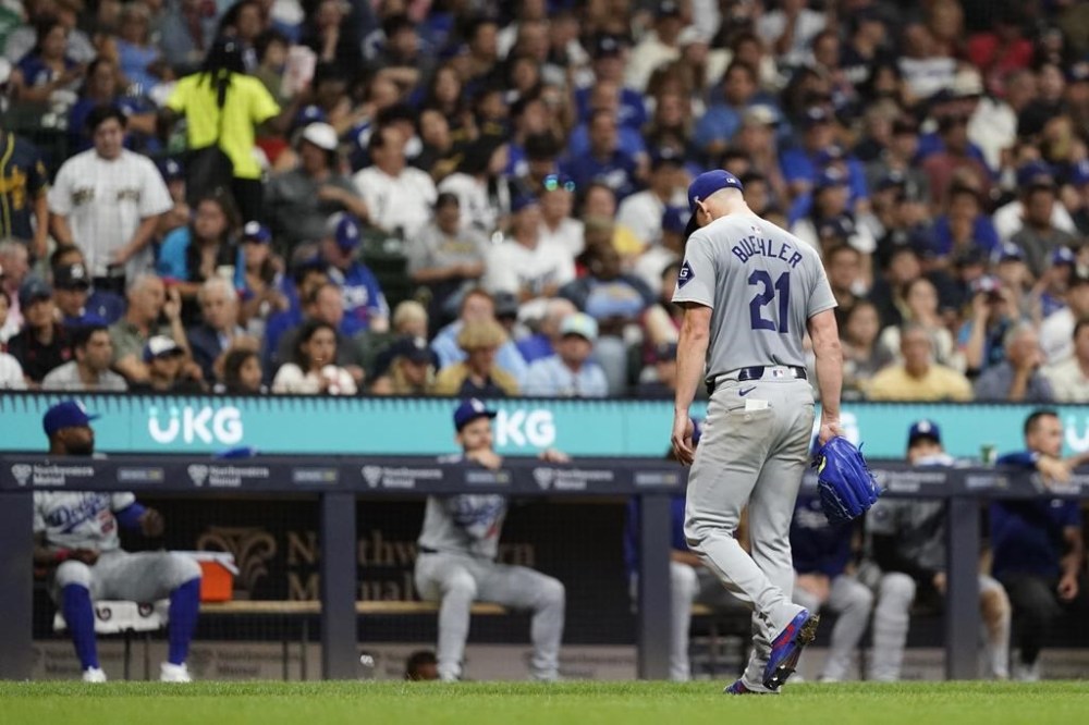 Los Angeles Dodgers' Walker Buehler walks to the dugout after being removed during the fourth inning of a baseball game against the Milwaukee Brewers, Wednesday, Aug. 14, 2024, in Milwaukee. (AP Photo/Aaron Gash)