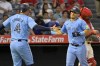 Toronto Blue Jays' Daulton Varsho is congratulated by George Springer (4) after hitting a three-run home run in the fifth inning of a baseball game against the Los Angeles Angels Wednesday, Aug. 14, 2024, in Anaheim, Calif. (AP Photo/Jayne-Kamin-Oncea)