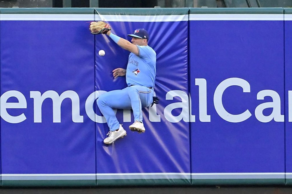 Toronto Blue Jays' Daulton Varsho reaches for a double off the wall hit by Los Angeles Angels left fielder Taylor Ward in the second inning of a baseball game Wednesday, Aug. 14, 2024, in Anaheim, Calif. (AP Photo/Jayne-Kamin-Oncea)