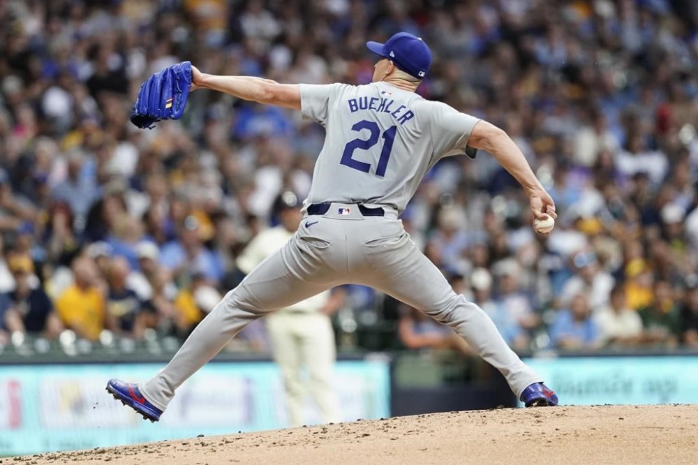 Los Angeles Dodgers' Walker Buehler pitches during the first inning of a baseball game against the Milwaukee Brewers, Wednesday, Aug. 14, 2024, in Milwaukee. (AP Photo/Aaron Gash)