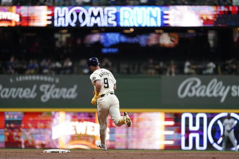Milwaukee Brewers' Jake Bauers rounds the bases after hitting a solo home run during the second inning of a baseball game against the Los Angeles Dodgers, Wednesday, Aug. 14, 2024, in Milwaukee. (AP Photo/Aaron Gash)