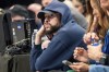 FILE - Puerto Rican recording artist Bad Bunny sits courtside during game 6 of an NBA basketball first-round playoff series between the Dallas Mavericks and the Los Angeles Clippers Friday, May 3, 2024, in Dallas. A federal judge halted a lawsuit by Bad Bunny’s sports representation firm against the Major League Baseball Players Association, ruling Thursday, AUg. 15, 2024, the case should be heard by an arbitrator. (AP Photo/Jeffrey McWhorter, File)