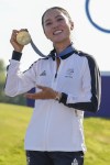 Lydia Ko, of New Zealand, poses for the cameras with her gold medal following final round of the women's golf event at the 2024 Summer Olympics, Saturday, Aug. 10, 2024, at Le Golf National, in Saint-Quentin-en-Yvelines, France. (AP Photo/Matt York)
