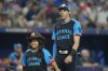 National League's Christian Yelich, of the Milwaukee Brewers, smiles during player introductions before the MLB All-Star baseball game, Tuesday, July 16, 2024, in Arlington, Texas. (AP Photo/Julio Cortez)