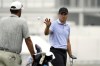 Jordan Spieth, right, catches a ball tossed to him on the driving range at the St. Jude Championship golf tournament Wednesday, Aug. 14, 2024, in Memphis, Tenn. The tournament is scheduled to begin Thursday. (AP Photo/Mark Humphrey)