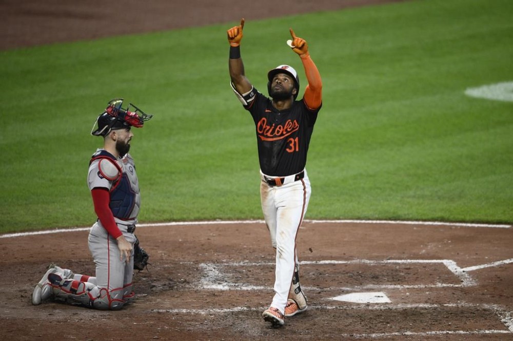 Baltimore Orioles' Cedric Mullins (31) celebrates his home run in front of Boston Red Sox catcher Connor Wong, left, during the fifth inning of a baseball game, Thursday, Aug. 15, 2024, in Baltimore. (AP Photo/Nick Wass)