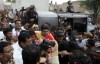 Men's javelin gold medalist, Arshad Nadeem, of Pakistan, center, is greeted by Pakistani people and his villagers with flower garlands upon his arrival at Mian Channu, Khanewal district, of Pakistan, Sunday, Aug. 11, 2024. (AP Photo/Asim Tanveer)