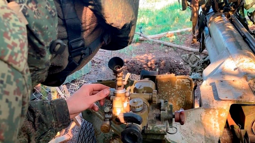 In this photo taken from video released by the Russian Defense Ministry press service on Friday, Aug. 16, 2024, a Russian soldier aims a 2B16 Nona-K towed gun in an undisclosed location. (Russian Defense Ministry Press Service via AP)