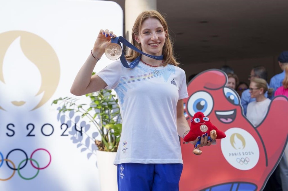 Romanian gymnast Ana Barbosu poses with the bronze medal for her women's artistic gymnastics individual floor performance at the Paris 2024 Olympics, after receiving it during a ceremony at the Romanian Olympic and Sports Committee, in Bucharest, Romania, Friday, Aug. 16, 2024. American gymnast Jordan Chiles called an arbitration panel's decision that dropped her out of the bronze medal position in the floor exercise at the Paris Olympics