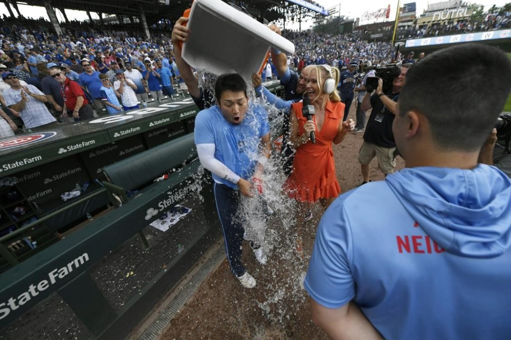 Chicago Cubs' Seiya Suzuki, center, is doused after hitting a walkoff single to defeat the Toronto Blue Jays in 10 innings of a baseball game in Chicago, Friday, Aug. 16, 2024. (AP Photo/Paul Beaty)