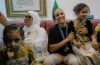 Olympic gold medalist in the the women's 66 kg boxing Algeria's Imane Khelif, second from right, smiles as she arrives home after returning from the 2024 Paris Olympic Games in Tiaret, Algeria, Friday, Aug. 16, 2024. (AP Photo/Anis Belghoul)