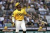 Pittsburgh Pirates' Andrew McCutchen watches his sacrifice fly during the fifth inning of a baseball game against the Seattle Mariners, Friday, Aug. 16, 2024, in Pittsburgh. (AP Photo/Matt Freed)