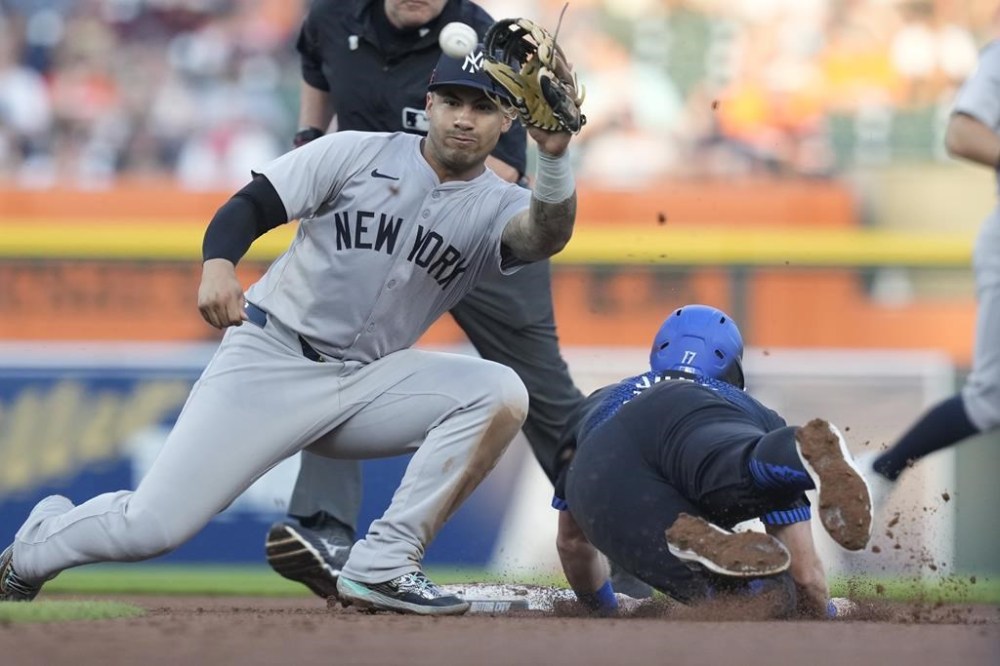 Detroit Tigers' Jace Jung is unable to beat the throw to New York Yankees second baseman Gleyber Torres and is out at second on an attempted steal during the fourth inning of a baseball game, Friday, Aug. 16, 2024, in Detroit. (AP Photo/Carlos Osorio)